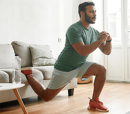 Young Middle Eastern man works out at home to avoid a hip and knee replacement