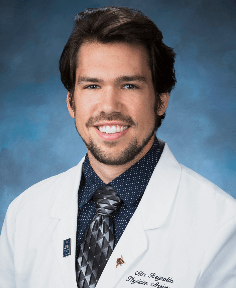 Headshot of mid-level provider Alex Reynolds in white scrubs