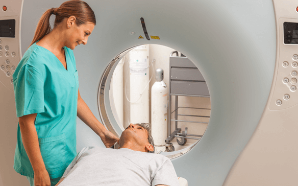 Happy patient undergoing mri scan at hospital.